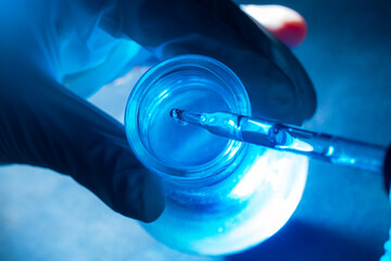 blue science test tube,Flask in scientist hand with drop of chemical liquid in test tube Science...