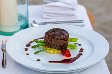 beef steak on plate,Close up view of grilled beef steak on plate over light wooden background. Top view, flat la