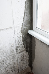 A lot of Black mold fungus growing on the wall at home. Dampness problem concept. Condensation on the window.