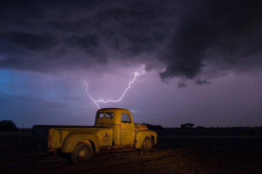 1951 International Harvester pickup truck at a farm under storm clouds with a lightning strike in Bennet, Nebraska, USA; Bennet Nebraska United States of America