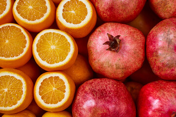 Fresh oranges and pomegranate fruits background. Healthy and tasty nutrition