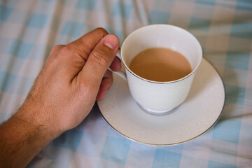 hand holding a cup of tea