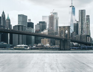 Empty concrete dirty embankment on the background of a beautiful NY city skyline and Brooklyn bridge at morning, mock up