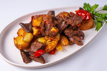 baked potatoes with meat and tomatoes on a white background