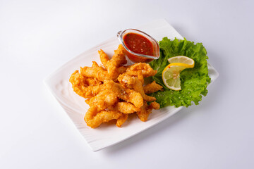 fried chicken meat with tomato sauce on a white background