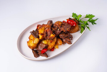 baked potatoes with meat and tomatoes on a white background