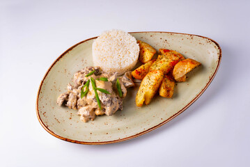 mushrooms in sauce with potatoes and rice on a white background