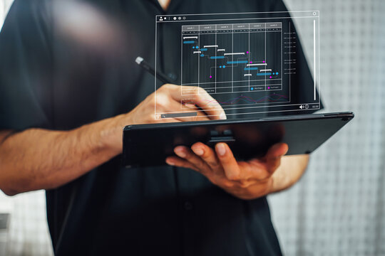 Analyst working with computer in Business Analytics and Data Management System to make report with KPI and metrics connected to database. Corporate strategy for finance, operations, sales, marketing.