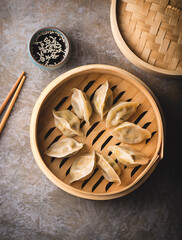 Chinese dumplings on a steamer, soy sauce and chopsticks. Traditional Chinese, Asian dish. Dim sum...