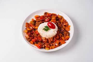 stewed vegetables with meat and boiled rice. on a white background