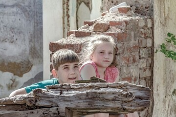Children in an abandoned and destroyed building in the zone of military and military conflicts. The...