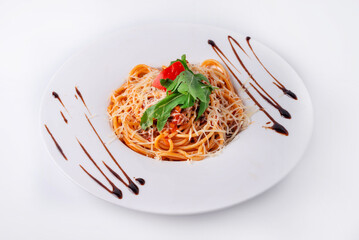 pasta with meat, vegetables, sprinkled with cheese on a white background