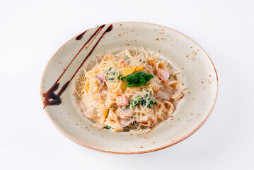 pasta with fish, sprinkled with cheese on a white background