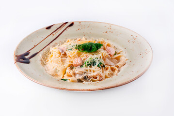 pasta with fish, sprinkled with cheese on a white background