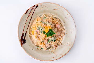 pasta with fish, sprinkled with cheese on a white background