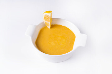 pumpkin soup served in a restaurant on a white background