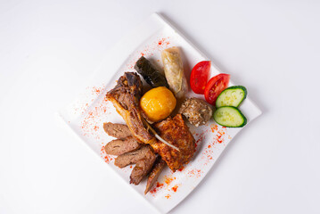 cold cuts, fried meat with potatoes, tomatoes and cucumbers, served in a restaurant on a white background