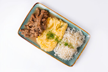 stewed meat with mashed potatoes and rice, served in a restaurant, on a white background