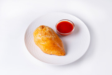 samsa with tomato sauce on a white background
