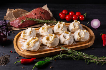 semi-finished products, manti with beef meat, on a black background