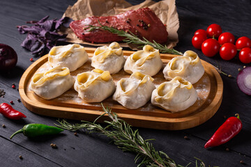 semi-finished products, manti with beef meat, on a black background