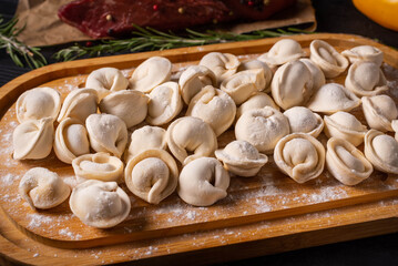 semi-finished products, dumplings with ground beef on a black background