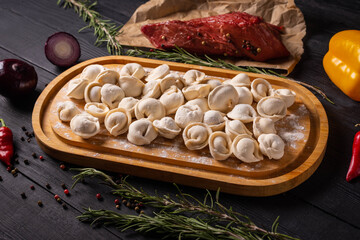 semi-finished products, dumplings with ground beef on a black background
