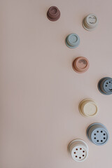 Modern Scandinavian nordic style baby toys on pastel pink background. Set of stacking tower cups in...