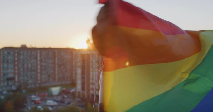 Young Black Woman Waving the LGBTQ+ Pride Flag