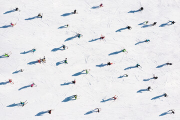 Ski resort. Aerial view of skiers. Winter sports. Snow slope in the mountains for sports. Group...