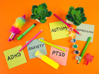 Mental health disorders handwritten on sticky notes with child supplies. Psychiatry, psychology concept