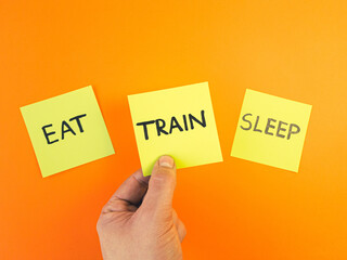 Eat train sleep motivational reminder handwritten on sticky notes. Workout motivation, fitness inspiration concept