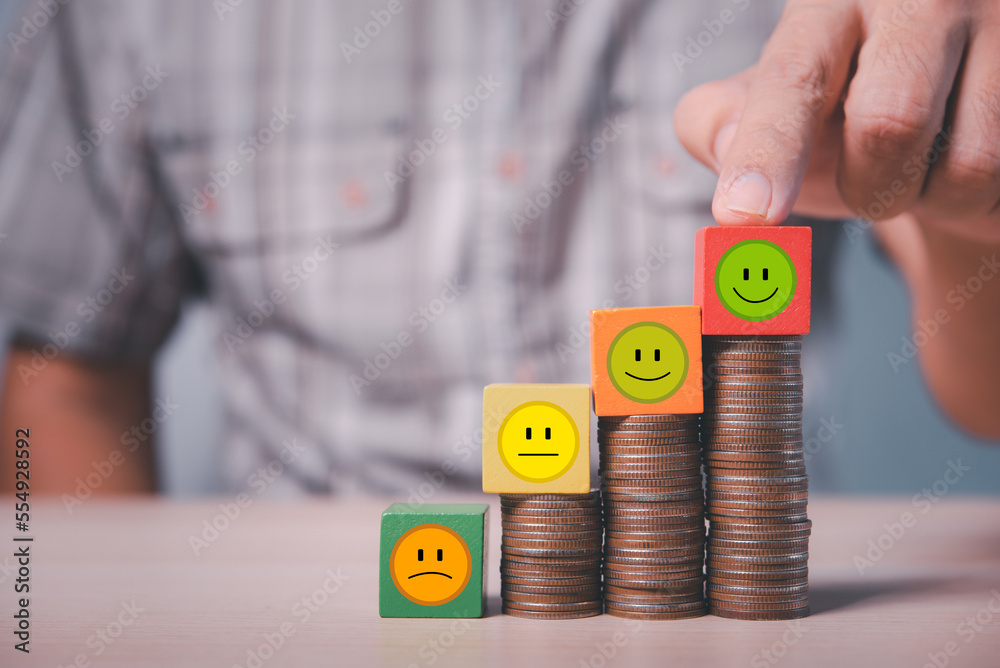 Aufkleber man hand point on tallest coin stack with smile icon wood cube