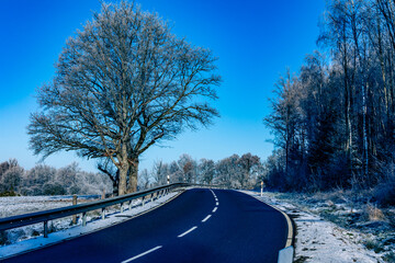 Winter empty asphalt road in the countryside. Travel concept