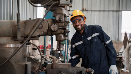 Industrial engineers inspect and perform maintenance on the machines at factory machines.