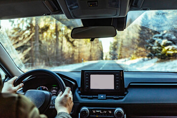 man driving a car on an winter road. Close-up of hands on a steering wheel. view from the driver's...