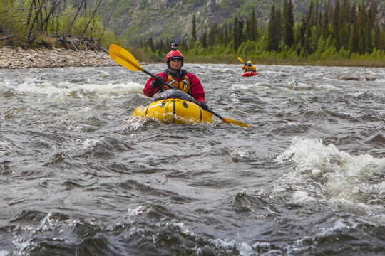 Two women packrafters negotiating a tributary of the Charley River in summertime, Yukon&ndash;Charley Rivers National Preserve; Alaska, United States of America