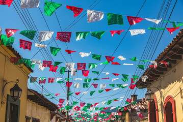 Garlands strung across a street between buildings; San Cristobal de las Casas, Chiapas, Mexico