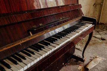 Fototapeta na wymiar Old piano keyboard in abandoned building. Close up view