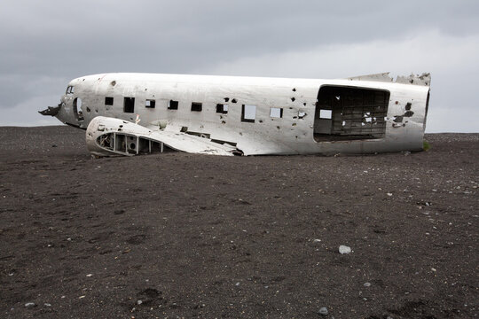 An abandoned United States Navy plane crashed and rests in black sand.; Solheimasandur, Iceland