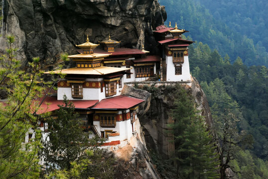 Taktsang Lhakhang, known as The Tiger's Nest, is a monastery clinging to a vertical granite cliff.; Paro, Bhutan