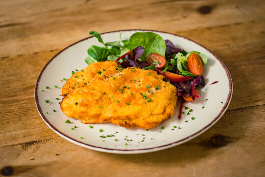 Escalope with salad on a plate; Studio