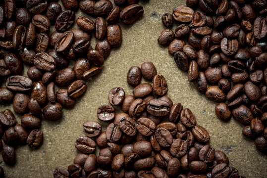 Roasted coffee beans on a grey surface; Studio