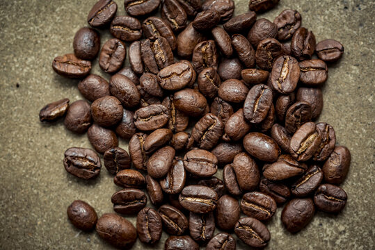 Roasted coffee beans on a grey surface; Studio