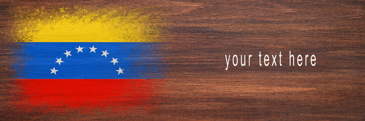 Flag of Venezuela. Flag is painted on a wooden surface. Wooden background. Plywood surface. Copy space. Textured background