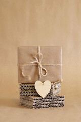 Zero waste Valentine's day. Handmade brown paper gift box with wooden heart-shaped ornament....