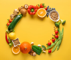 Circular composition from a set of food for healthy and diet eating on a yellow background top view