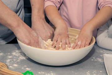 girl's hands kneading cookie dough with potato in the kitchen