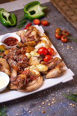 top view of assorted different chicken dishes on a white plate