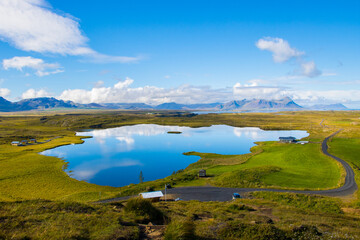 Green Landscape with Lake and Sky with Clouds Beautiful Helgafell, Iceland with Hills and Ocean